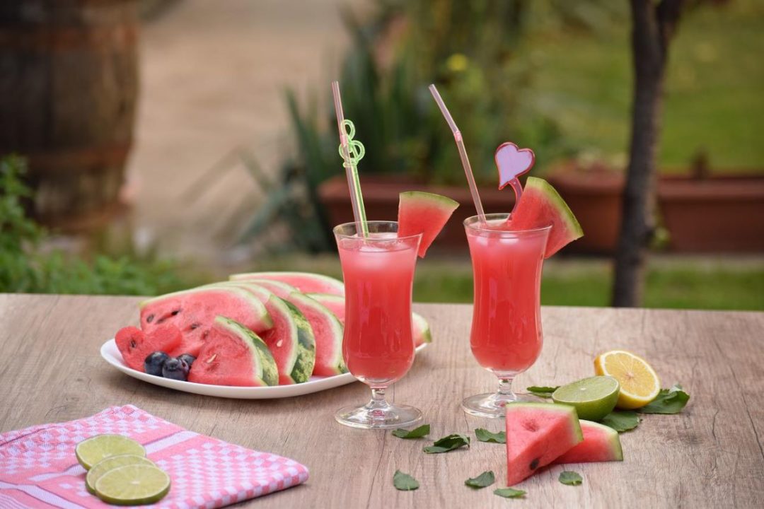 sliced-watermelon-on-plate-next-to-fancy-watermelon-drinks