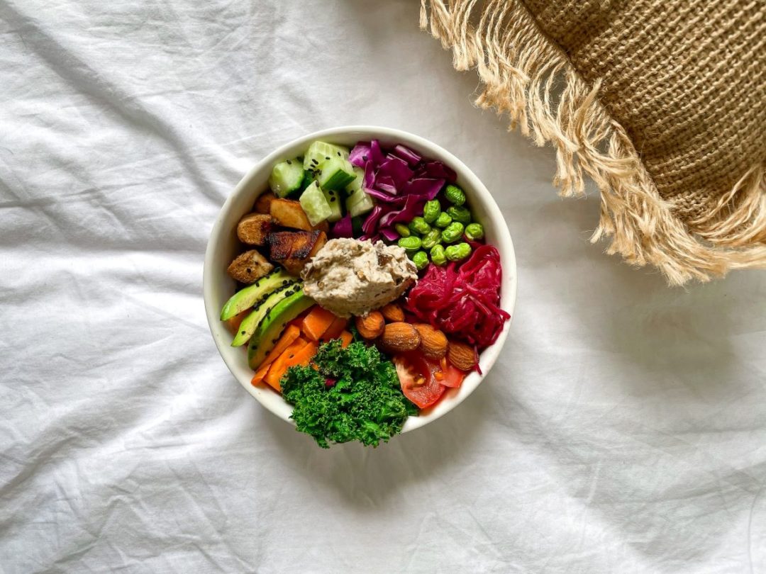 protein-bowl-on-white-bed-with-tan-blanket