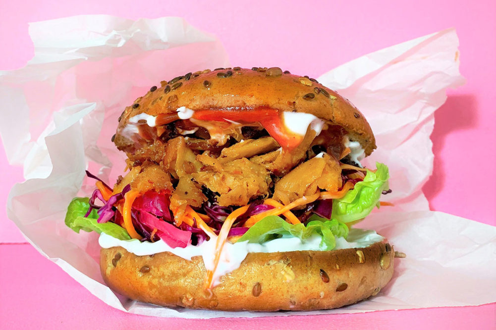 plant-based-product-on-bun-with-pink-background