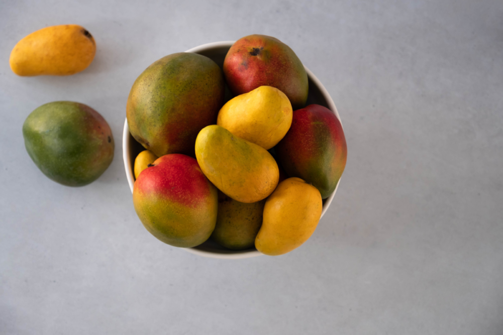 bowl-of-mangoes-on-gray-surface