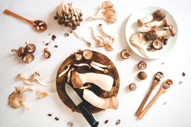 variety-of-mushrooms-with-knife-on-white-background
