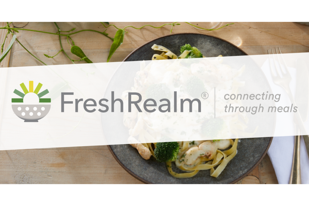fresh-realm-logo-over-plated-meal-on-wooden-surface