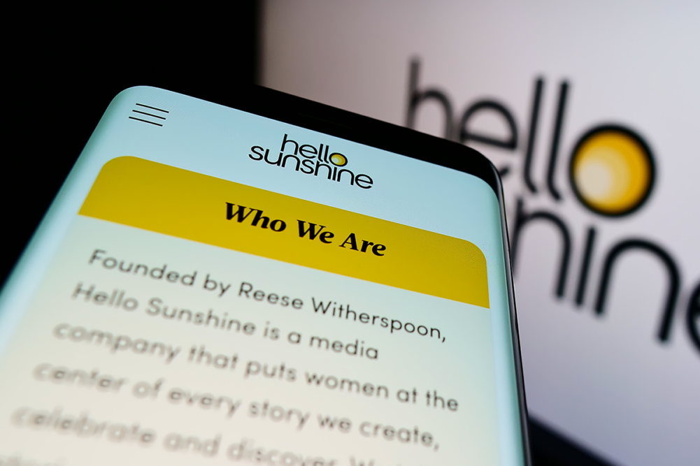 phone screen showing Hello Sunshine logo and information about the company