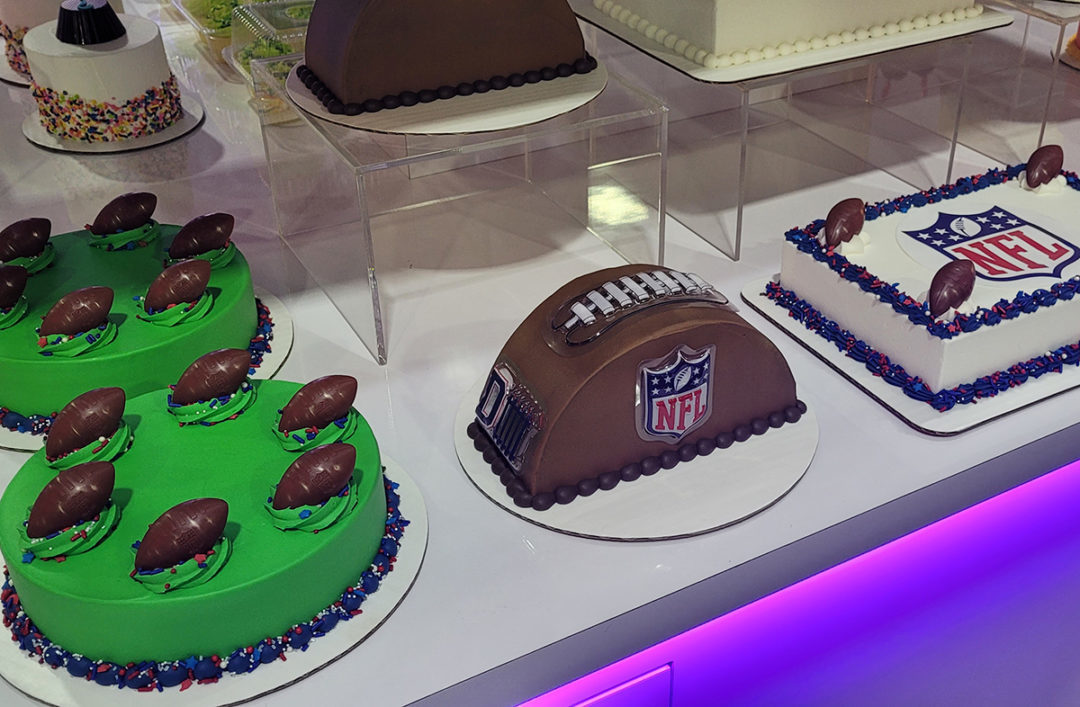 football-themed cakes in a display case