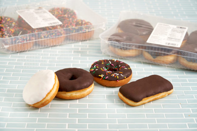 variety of donuts on pale blue tile surface
