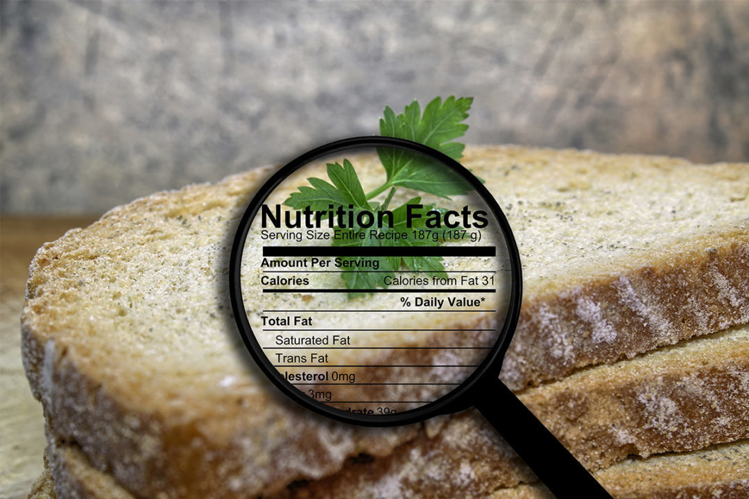 sliced bread with a magnifying glass over it showing nutrition label