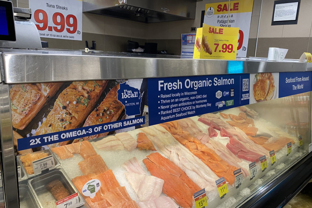 seafood case with sale signs