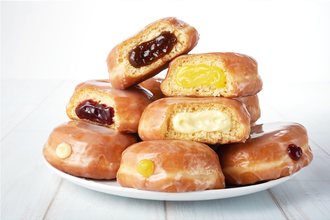 pile of filled donuts on a white plate with a white background