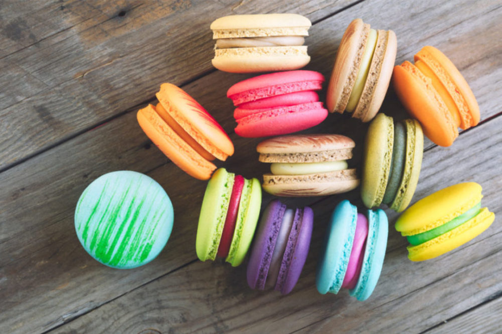 colorful macarons on wooden surface