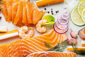 banner of fresh seafood on a table with spices, vegetables and olive oil: fresh and smoked salmon, shrimp and crab sticks for a supermarket or fish sushi restaurant.