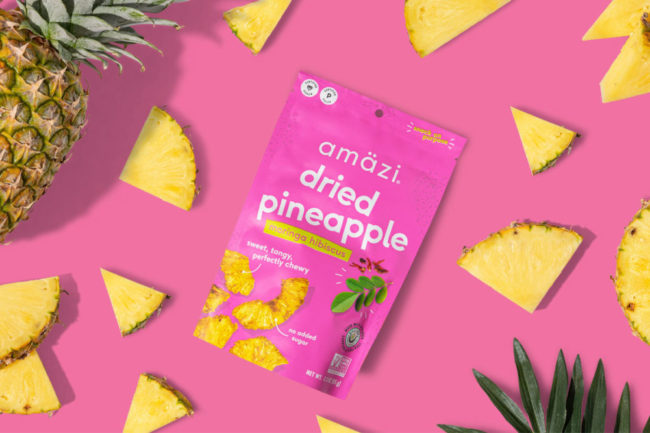 Amazi dried pineapple snacks on pink background