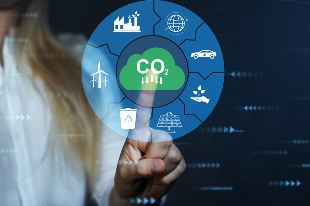 woman pointing at technology icons that say CO2