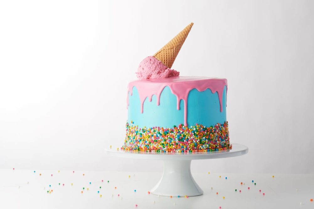 blue and pink cake with an ice cream cone on top