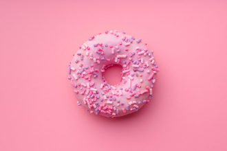 Pink donut on a pink background