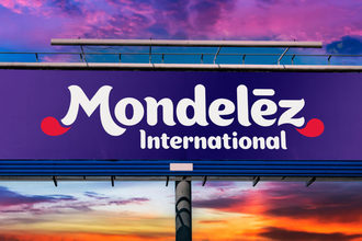 Mondelez logo on a billboard with a sunset sky in the background