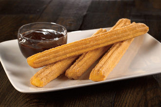 churros with chocolate sauce on a plate