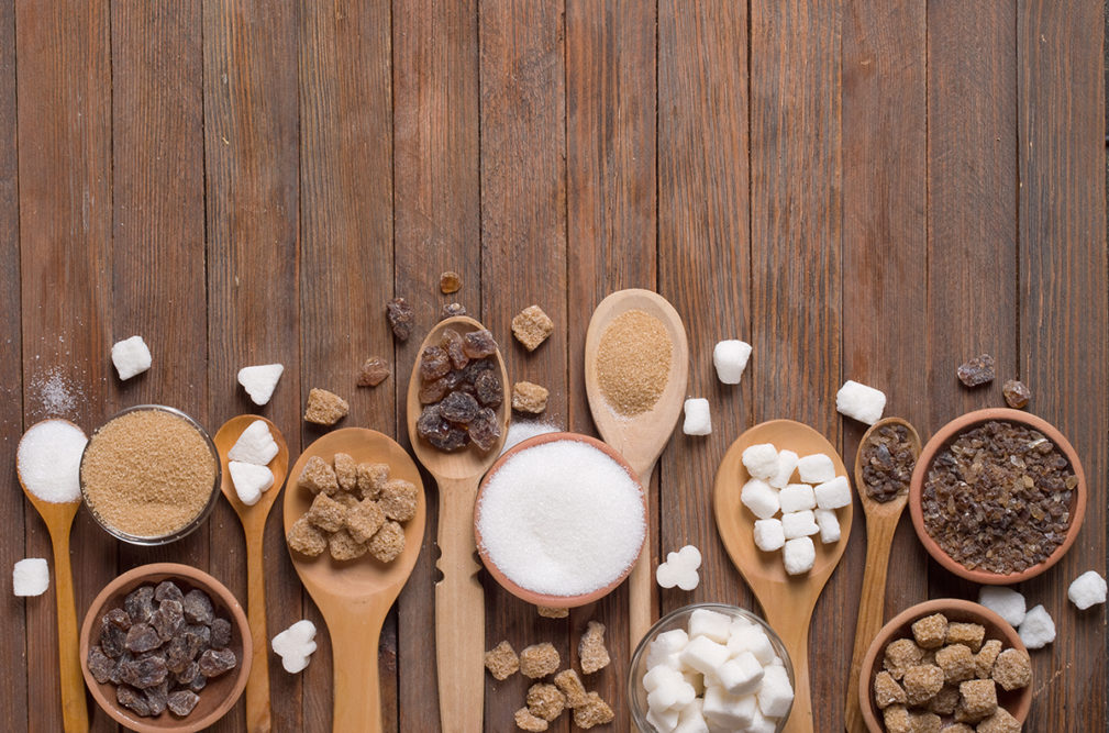 Various kinds of sugar on wooden spoons