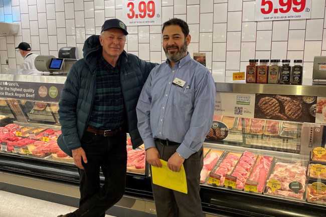 Local Niman Ranch hog farmer Tom Arnold (left) meets with the meat manager of Mariano's Lombard location.