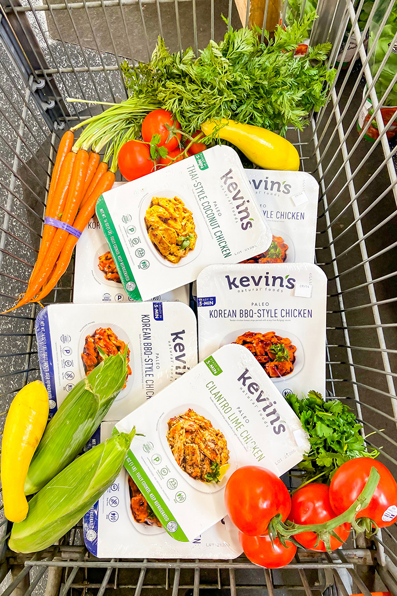 kevin's natural foods products in a shopping cart with produce items