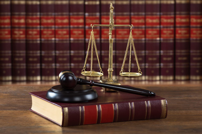 Gavel and book with justice scales on a desk