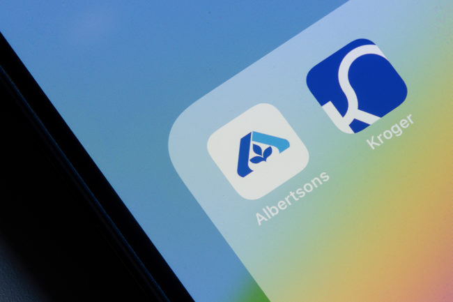 Albertsons and Kroger mobile app icons are seen on an iPhone