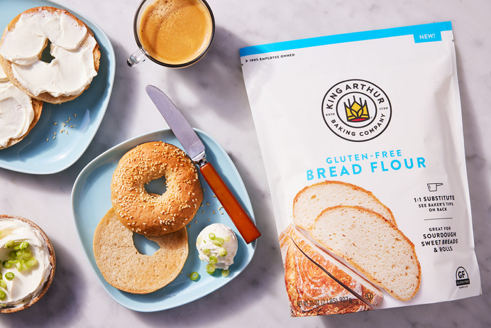 King Arthur Gluten-Free Bread Flour packaging next to bagels on plates