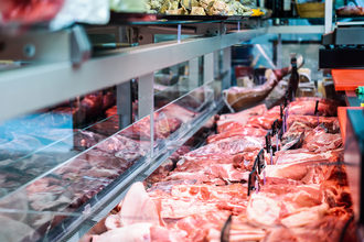 Fresh raw red meat in refrigerated display