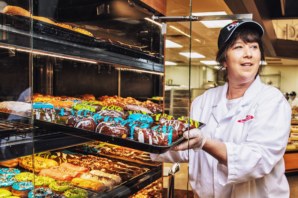 Dawn Foods employee with a pan of baked goods