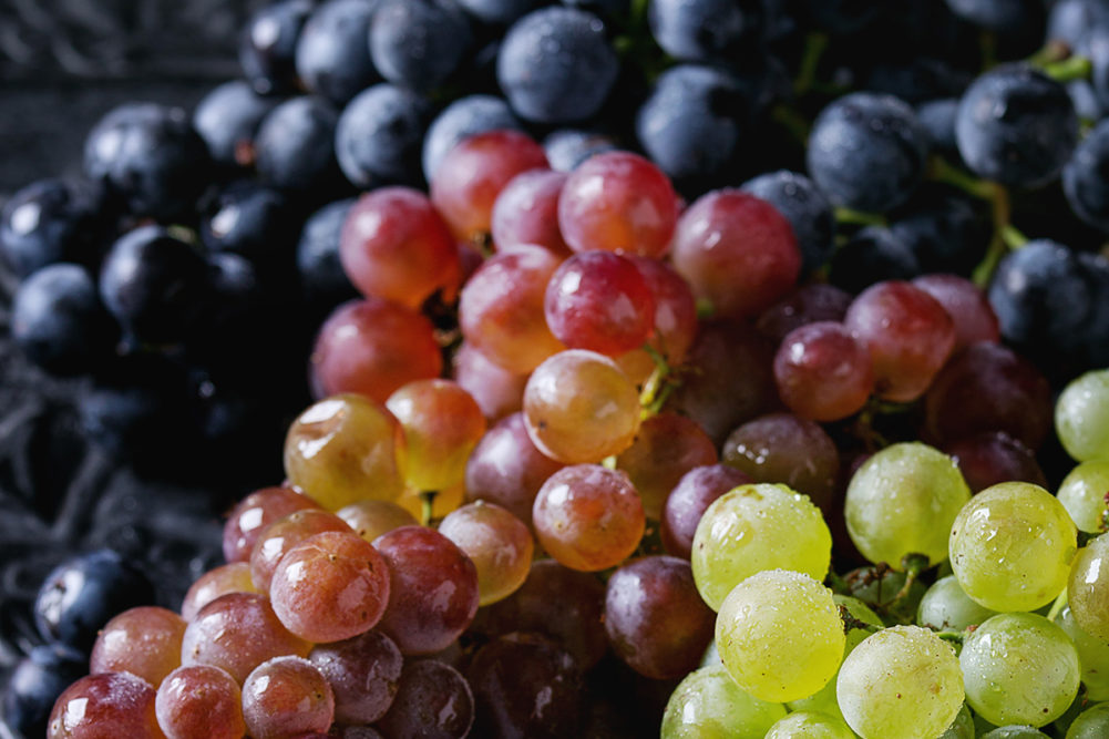 Variety of three type fresh ripe grapes dark blue, red and green. 