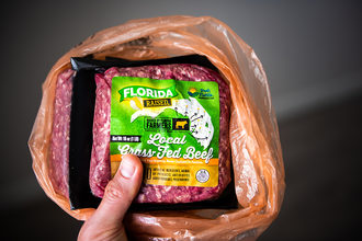 Fresh from Florida brand sign closeup of packaged free range local grass-fed raised red raw beef ground meat bought at Costco