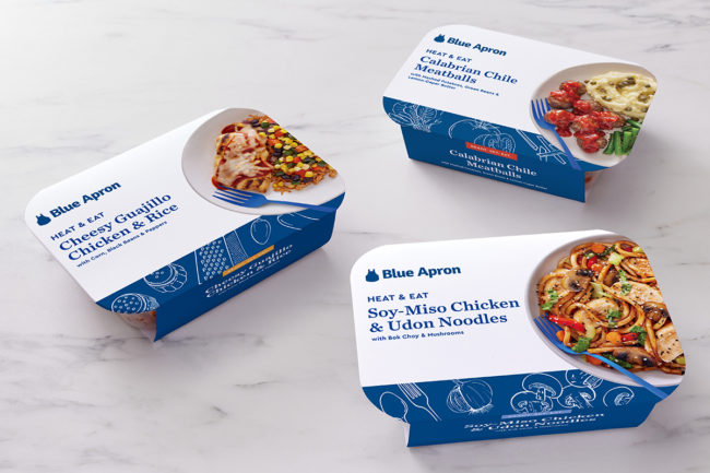 Blue Apron heat and eat meals in packaging on a white counter