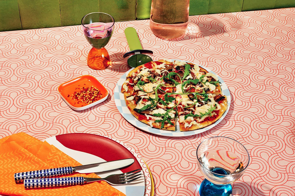 vegan pizza arranged on an orange table cloth