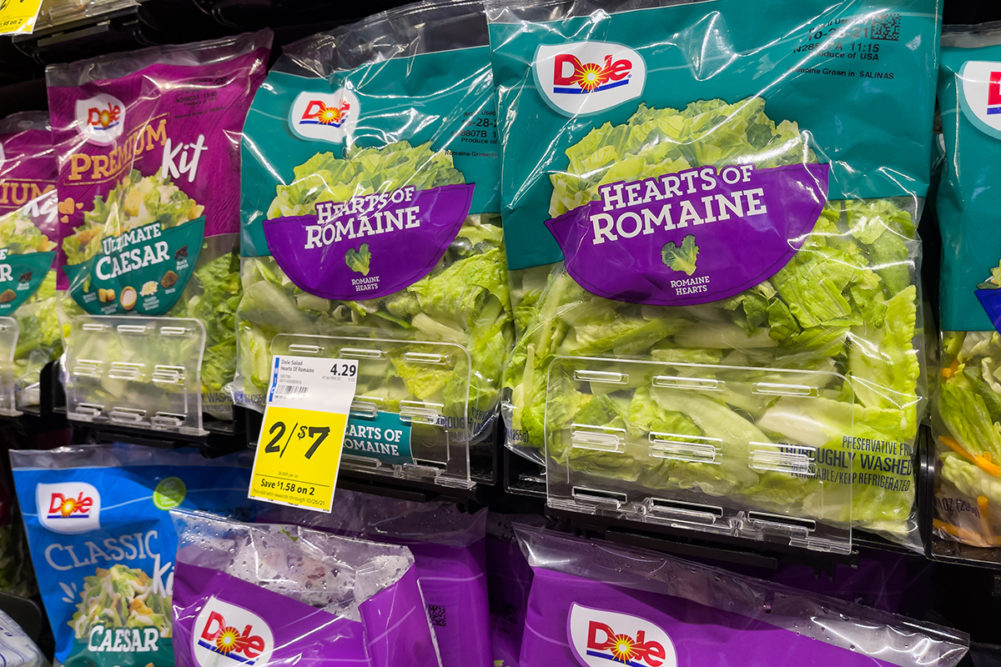 Dole salad kits on a shelf in a grocery store