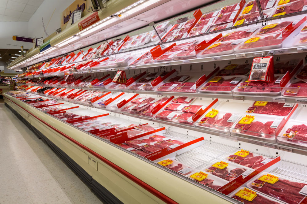 grocery store shelves of packaged meat