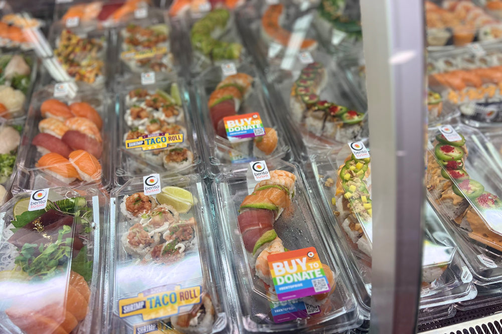 glass case with sushi rolls displayed