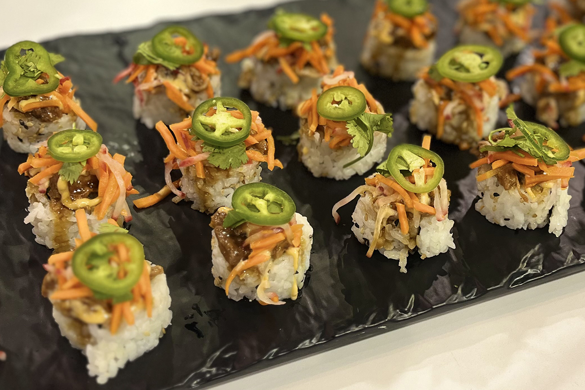 Hissho Sushi rolls on a black tray