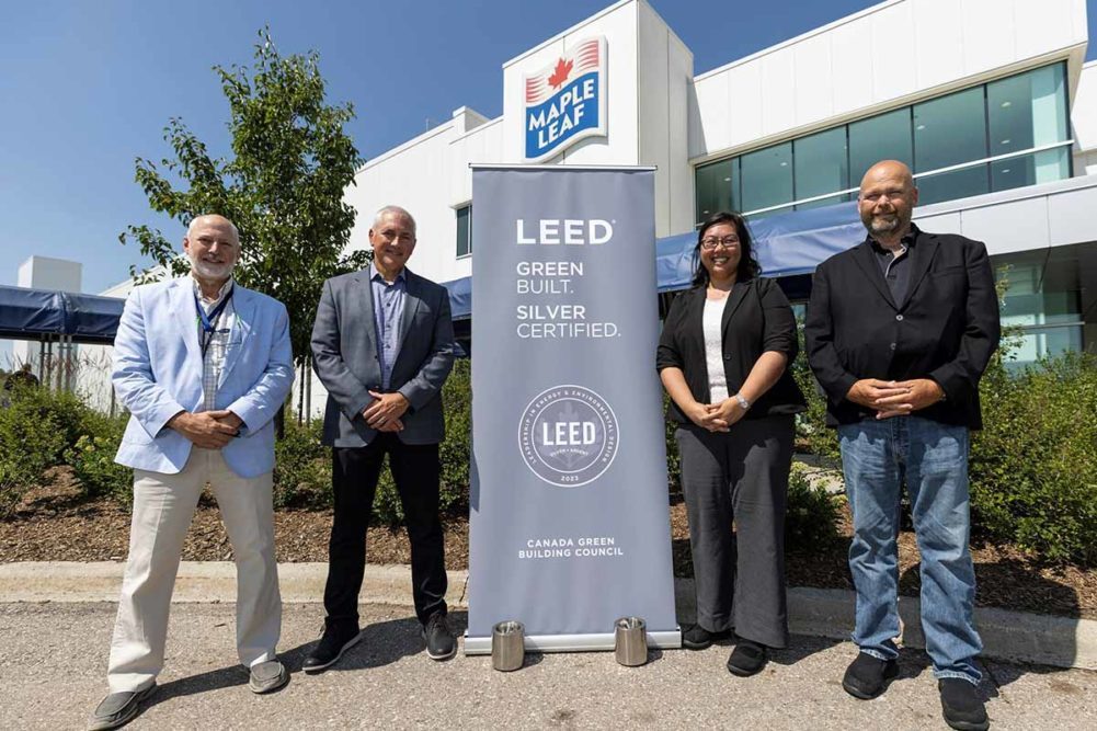Maple Leaf Foods personnel with LEED sign