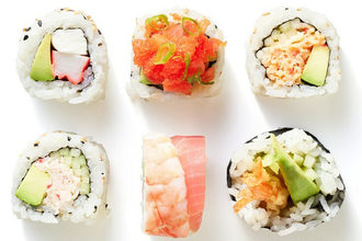 six sushi rolls on a white background