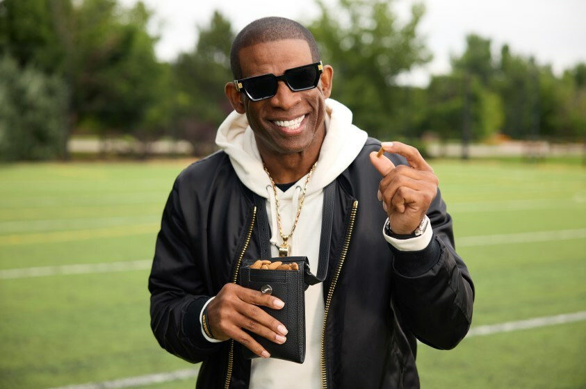 Deion Sanders with a bag of almonds