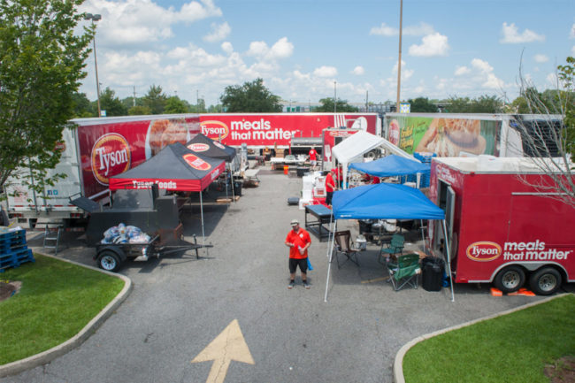 tents with Tyson Foods logo set up to donate food
