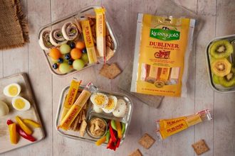 meal prep dishes with Kerrygold cheese snack sticks and other foods