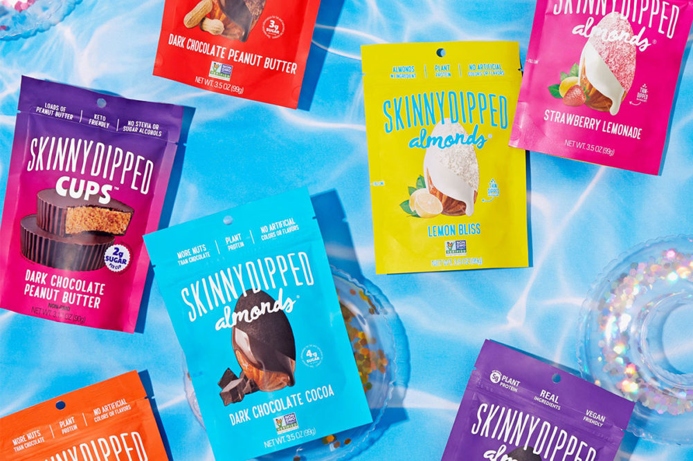 Bags of SkinnyDipped products on a blue background