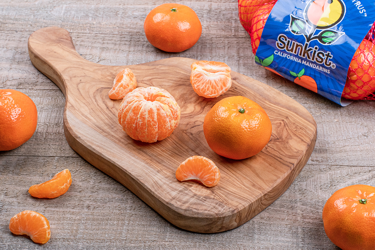 Sunkist Mandarin oranges on a wooden cutting board
