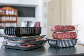 raw meat in packaging sitting on a kitchen counter