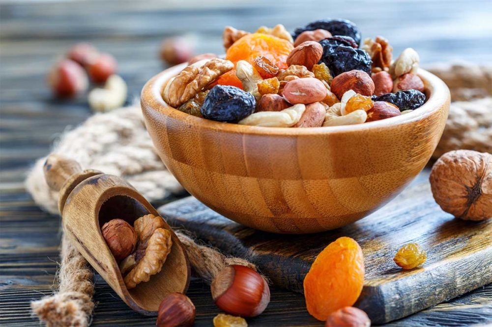 dried fruit and nuts in a wooden bowl