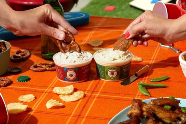 Sartori Cheese dips with hands dipping pretzels in them