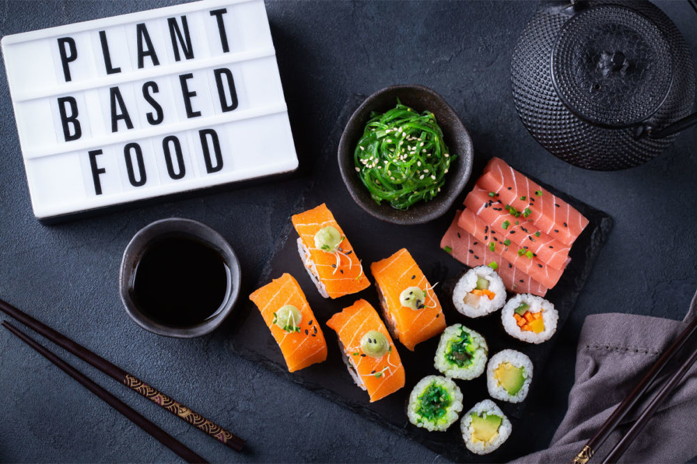 sushi with "plant based food" sign next to it
