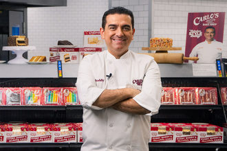 Buddy Valastro in front of a Walmart display.