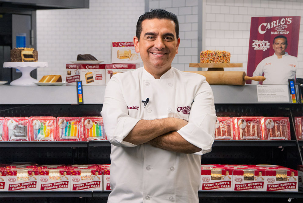 Buddy Valastro in front of a Walmart display.