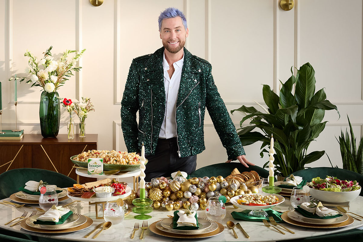 Lance Bass standing behind a holiday table
